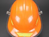 an orange hard hat on a black background