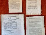 three old papers are sitting on a table next to a pair of scissors