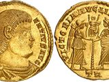 a gold coin with an image of a man and a woman on it