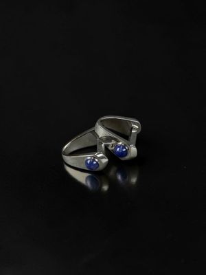 a close up of a pair of silver rings with blue stones