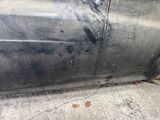a dirty car that is parked on the side of the street