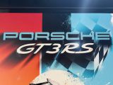 a sign that says porsche gtrs on the side of a building