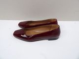 red shoes on a white surface with a white wall in the background