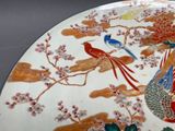 a plate with a bird and flowers on it