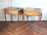two wooden tables with bowls on them on a hard wood floor