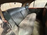 an old car with a leather seat in the back of it