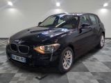 une photo d'une voiture bmw noire garée dans un garage