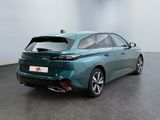 the rear end of a blue car in a large room