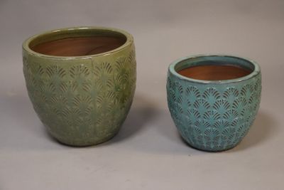 two pots sitting next to each other on a table
