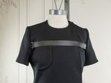 a black dress with a leather belt on a mannequin