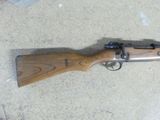 the rifle is laying on the floor next to the floor