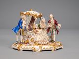 a figurine of a man and a woman on a carriage