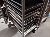 several trays of food sit in a stainless steel oven