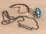 a necklace and a bracelet with a name tag on it