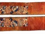 two pieces of cloth with designs on them on a white surface