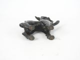 a black cat figurine sitting on a white surface