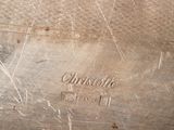 a close up of a silver plate with a name on it