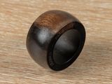 a close up of a wooden ring on a wooden surface