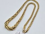a gold chain with a tag on it and a tag attached to it