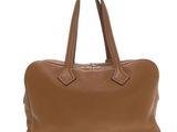a brown leather handbag on a white background