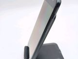 a cell phone that is sitting on top of a stand