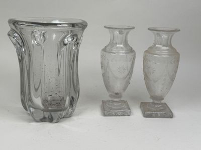 three glass vases sitting next to each other on a table