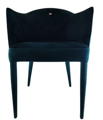 a dark blue velvet chair with a curved back and legs