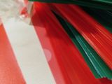 a pile of red, green, and red plastic straws