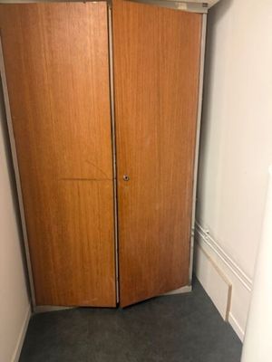 two wooden doors in the corner of a room