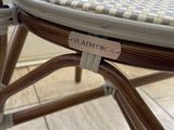 a close up of a wicker chair with a label on it