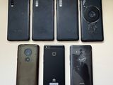 several different cell phones are lined up on a table