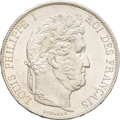 a close up of a coin with a man ' s face on it