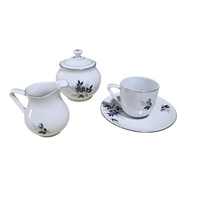 three cups and a saucer on a white table
