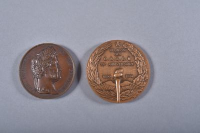 an image of a coin and a medal on a blue surface
