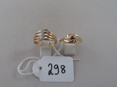 pair of gold and diamond rings with price tag on white background