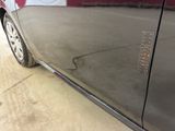 a close up of a car ' s door handle with a sticker on it
