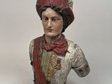 statue of a bust of a man wearing a red hat and scarf