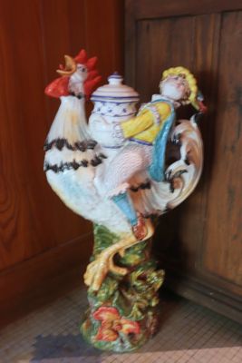 a figurine of a rooster on a table