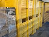 several yellow crates are stacked on top of each other in a warehouse