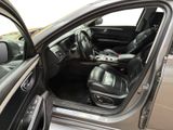 the interior of a car with the door open and the driver ' s seat down