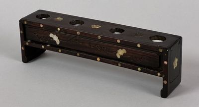 a small wooden box that has holes in it