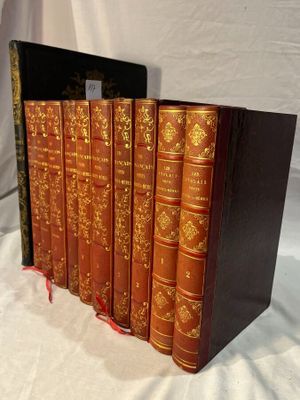 three books are stacked on top of each other on a white surface