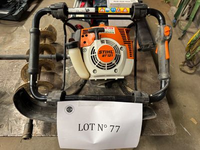 a small blower sitting on top of a pile of logs