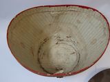 a white bowl with a red rim sitting on a table