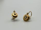a pair of gold earrings with a star and moon on them