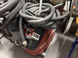 a pile of vacuums and other equipment on the floor