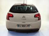 a white car that is parked in a white room