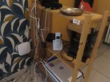 a table with a laptop on top of it in a room with yellow walls