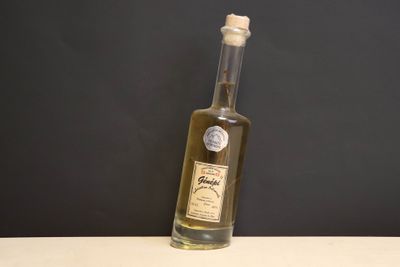 a bottle of olive oil sitting on a table