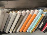a lot of books that are on a shelf